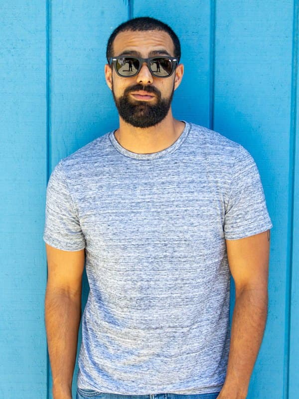 A man wearing William Painter The Hook titanium sunglasses outdoors
